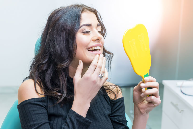 dental patient looking in mirror